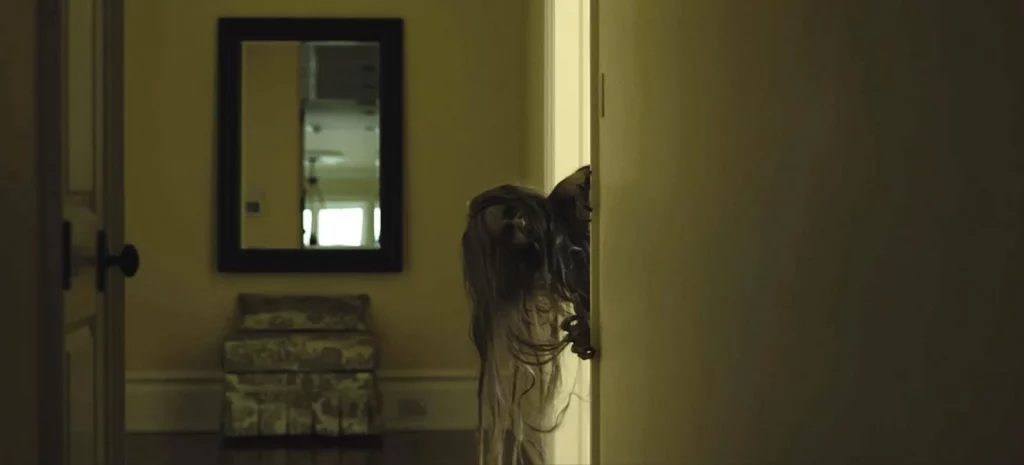 Scene from the movie Still/Born. Witch looking around the corner.